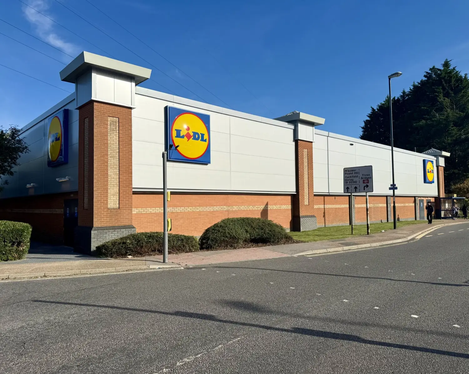 The Lidl Crawley store elevation in white composite panel above a brick plinth