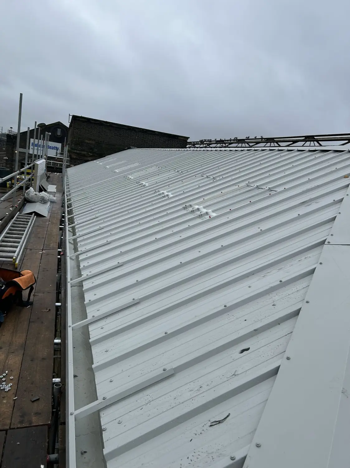 The same roof finished in new white profiled metal sheeting