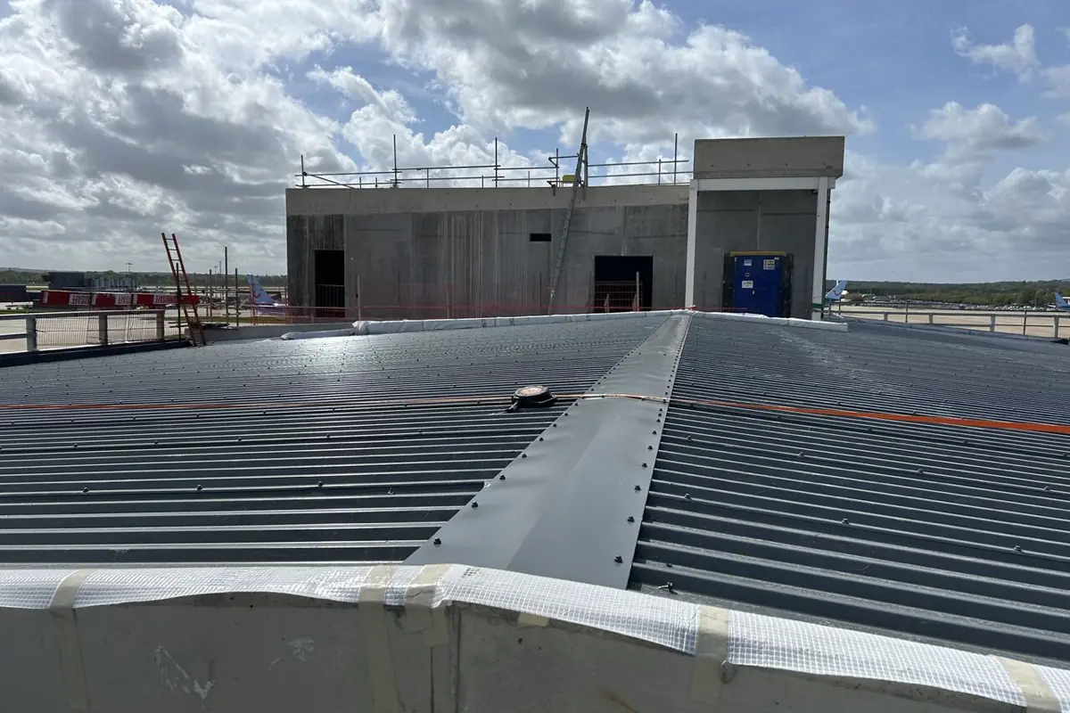 Metal roof sheeting running up to an in-situ concrete core at Gatwick