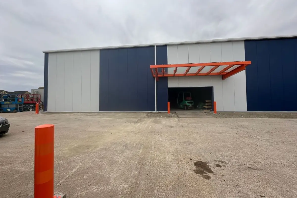 A navy and white clad unit with an orange loading bay canopy