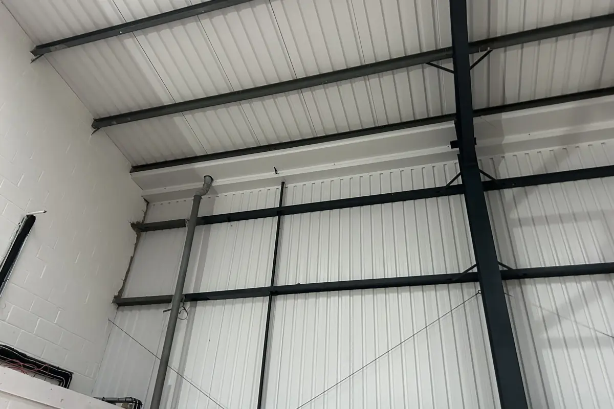 The inside of a new industrial unit showing insulated liner panels on the roof and walls