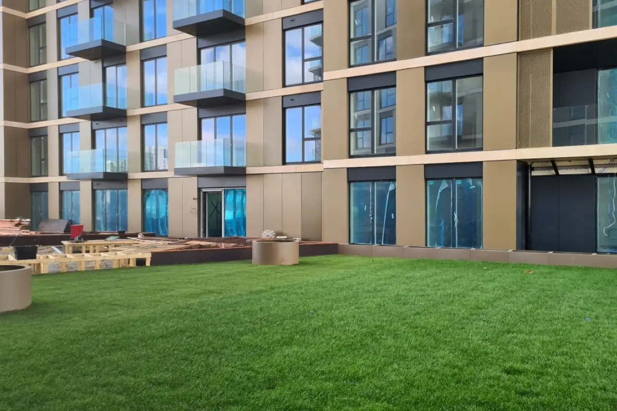 A residential block finished in bronze composite panels with perforated metal screens